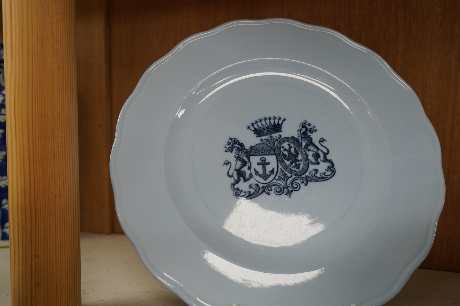 A Victorian Brown Westhead & Moore blue comport and two similar armorial plates, 23cm in diameter (3). Condition - good